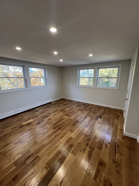 2705 State Highway Eastham, MA 02642 - Photo 23 of 42 an empty room with wooden floor and windows