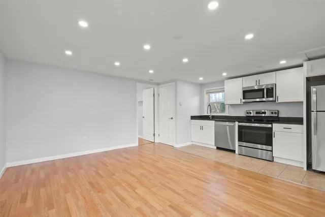 a large kitchen with kitchen island a stove a sink and a refrigerator