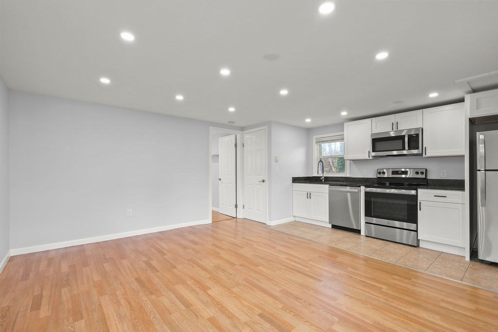 2705 State Highway Eastham, MA 02642 - Photo 6 of 42 a large kitchen with kitchen island a stove a sink and a refrigerator
