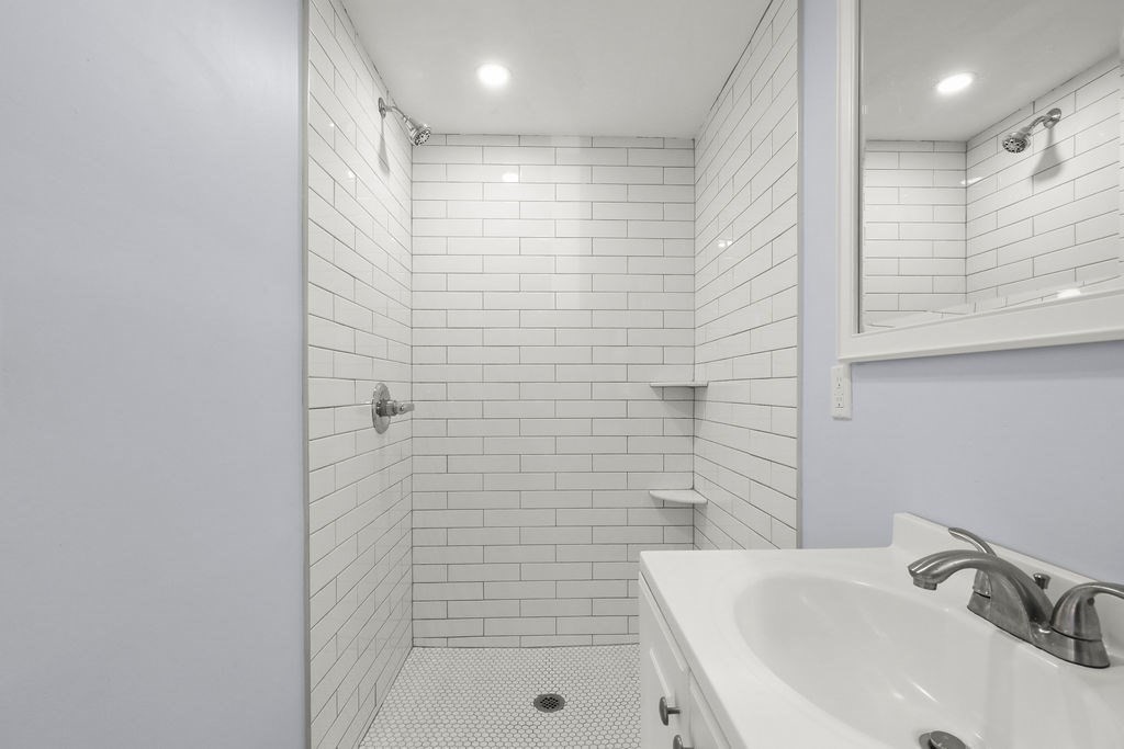 2705 State Highway Eastham, MA 02642 - Photo 10 of 42 a bathroom with a sink a shower and a mirror