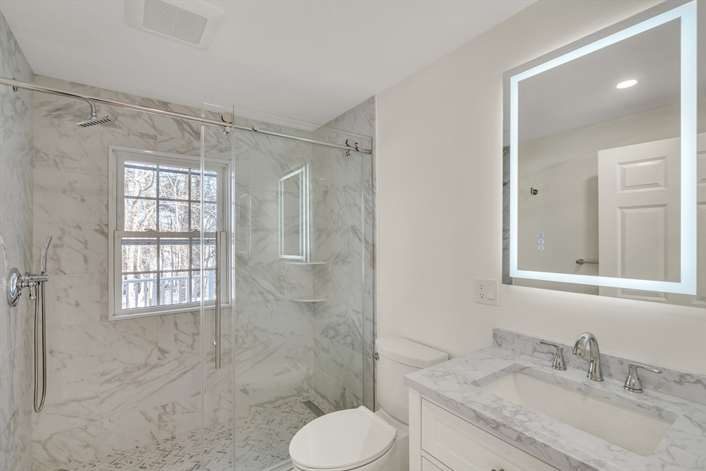 510 Common Street Walpole, MA 02081 - Photo 8 of 35 a bathroom with a granite countertop sink toilet and shower