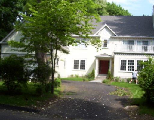 27 Stillview Road Stamford, CT 06902 - Photo 1 of 1 a view of a yard in front of a house with plants and large trees