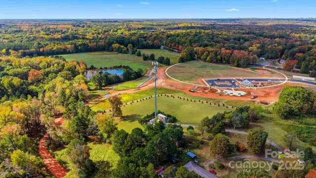an aerial view of a residential houses with outdoor space and swimming pool