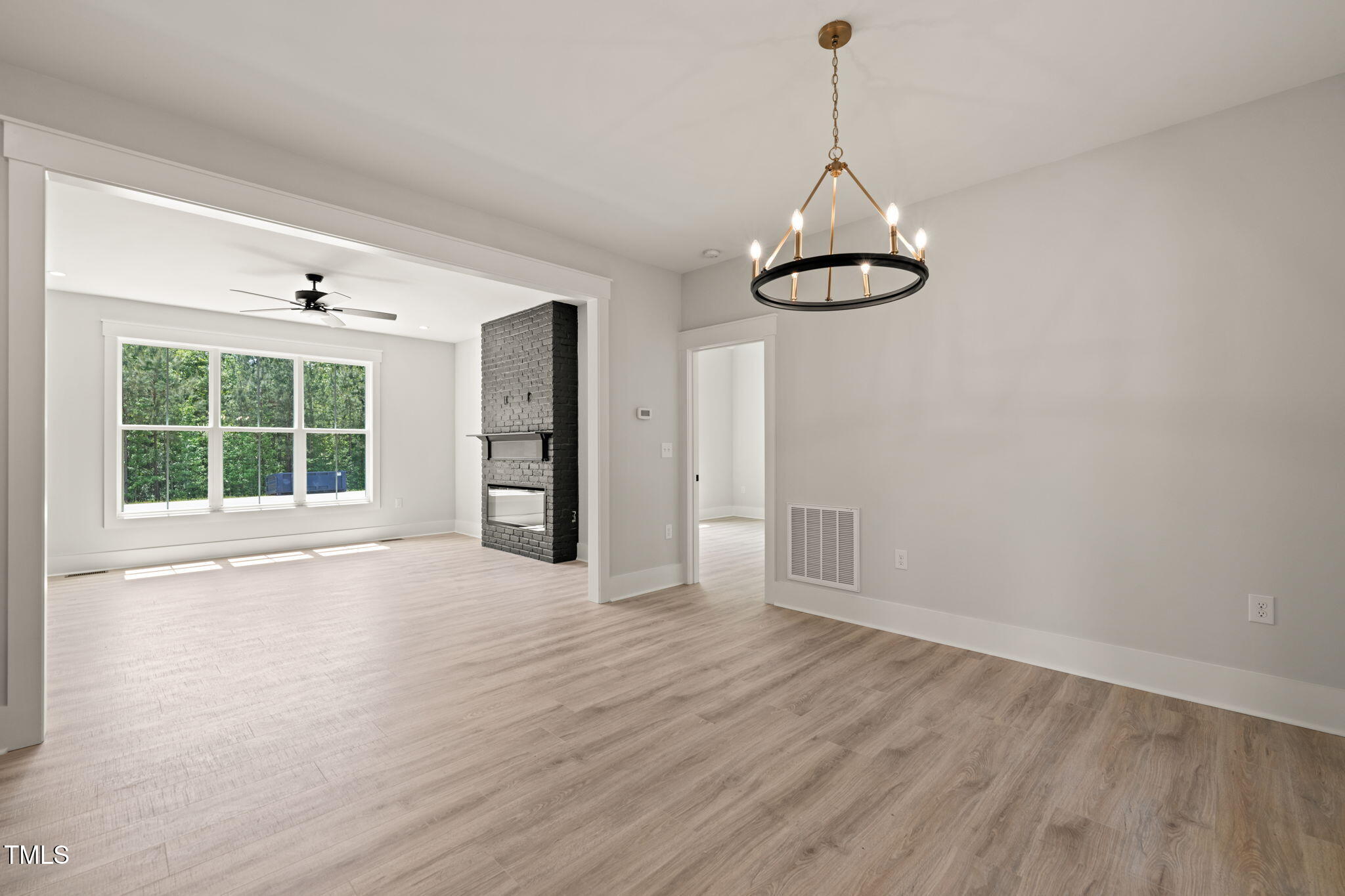 380 Pilot Ridge Road Zebulon, NC 27597 - Photo 11 of 42 a view of an empty room with wooden floor kitchen view and a window