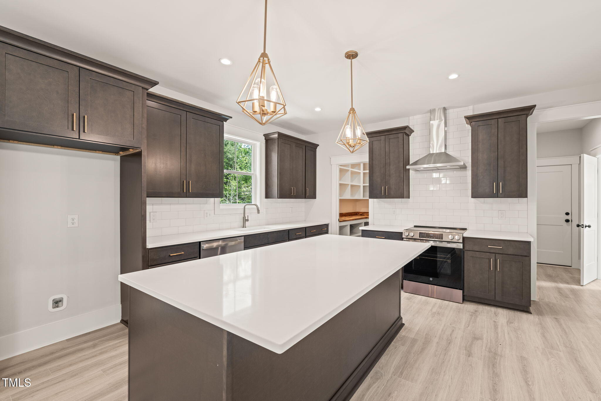 380 Pilot Ridge Road Zebulon, NC 27597 - Photo 13 of 42 a large kitchen with kitchen island a sink stainless steel appliances and cabinets