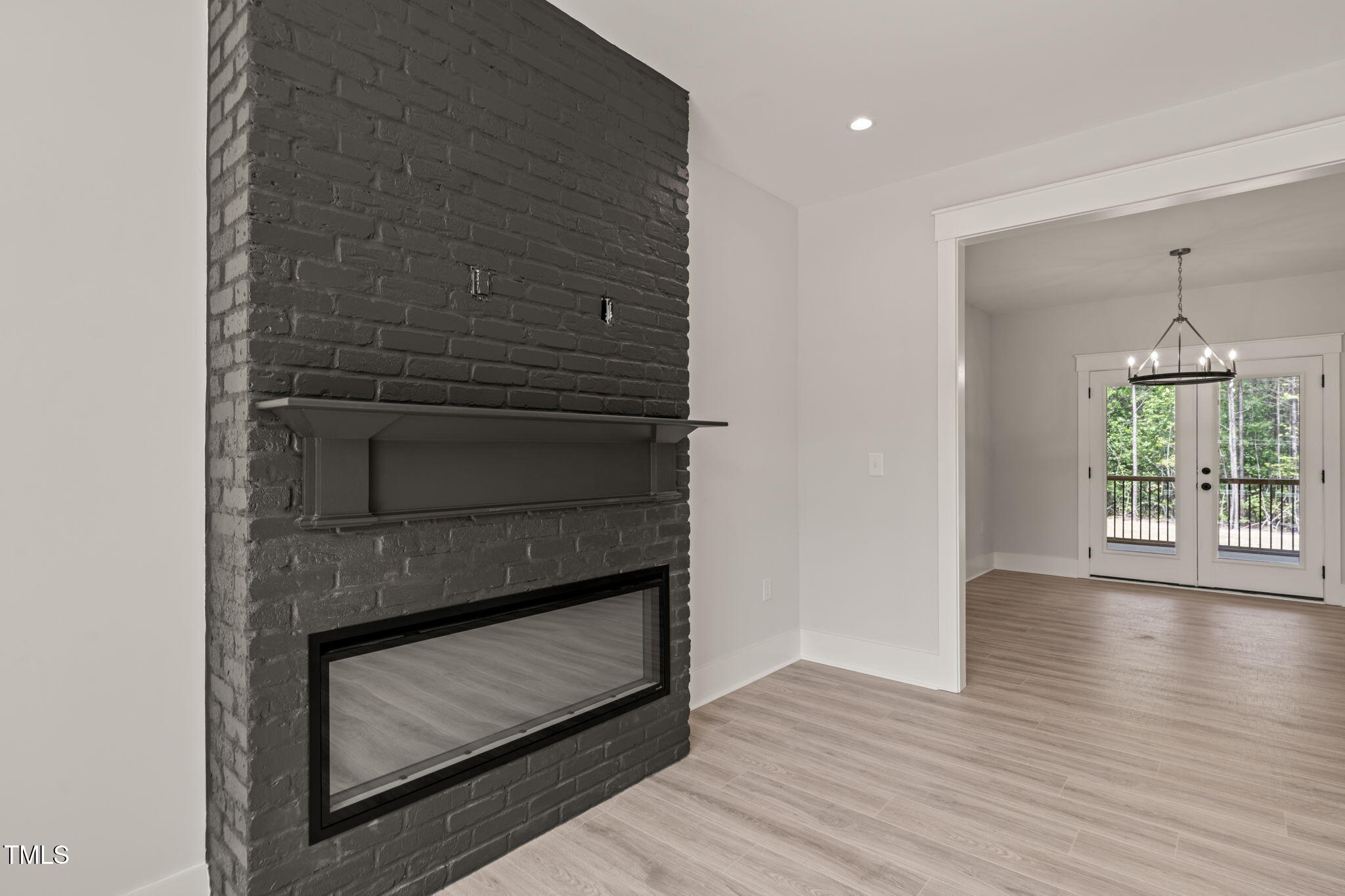 380 Pilot Ridge Road Zebulon, NC 27597 - Photo 8 of 42 a hallway with fireplace and wooden floor