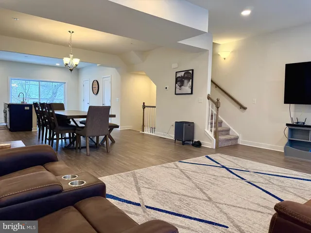a living room with furniture a dining table and a fireplace