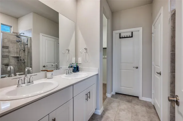a bathroom with a double vanity sink and mirror