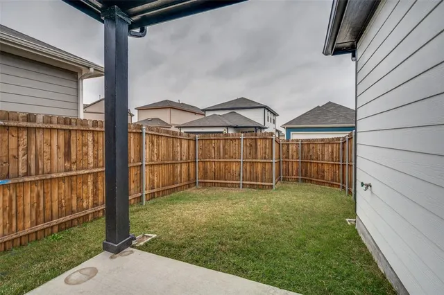 a view of a backyard with a garden and deck