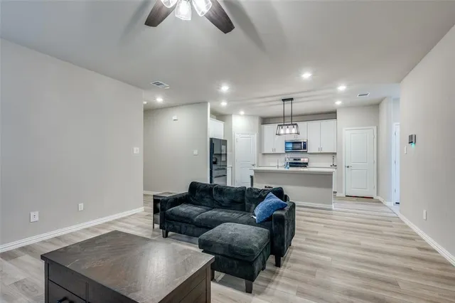 a living room with furniture and kitchen view