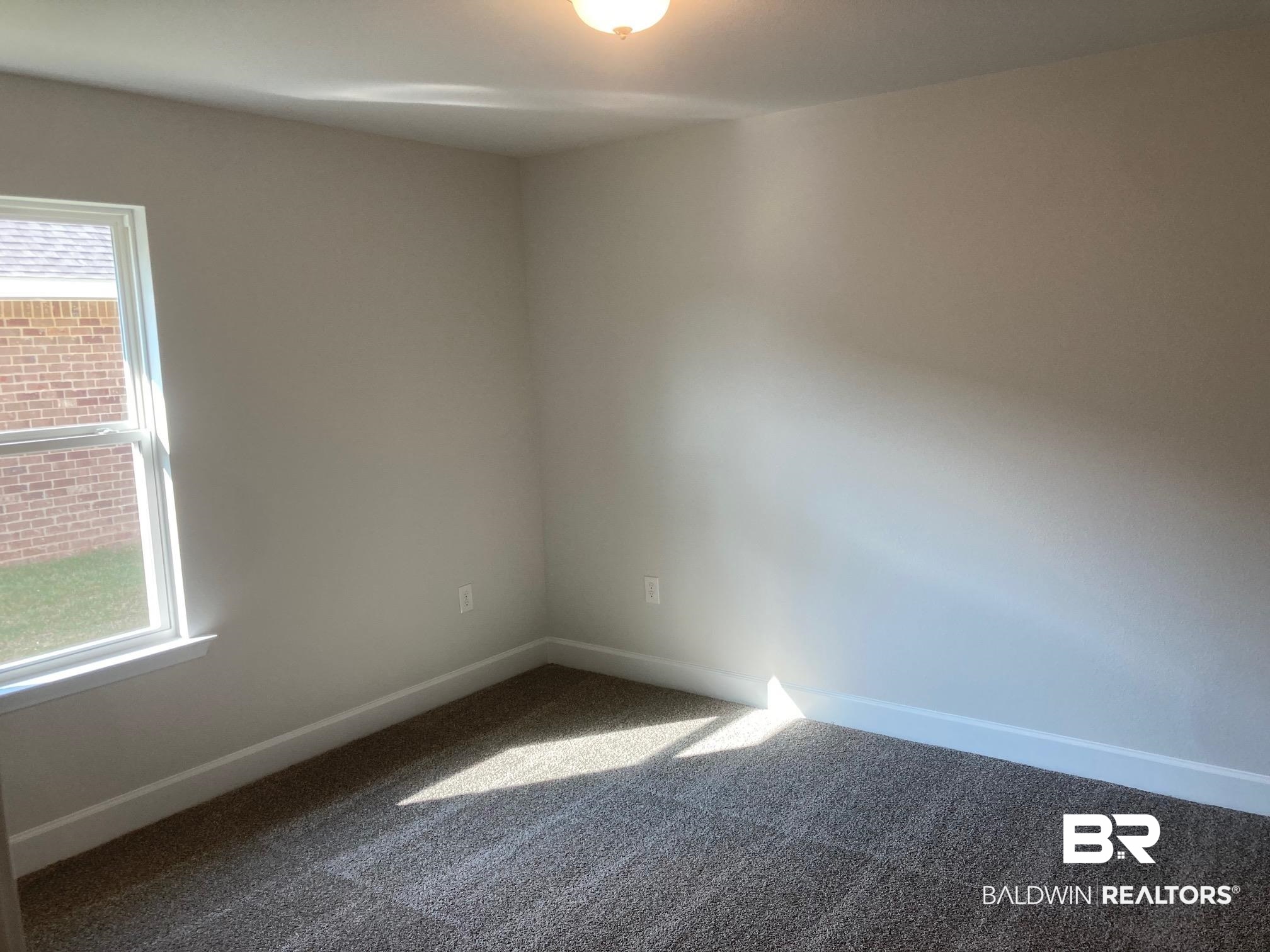 629 Revere Street Foley, AL 36535 - Photo 6 of 30 Unfurnished room featuring plenty of natural light and carpet