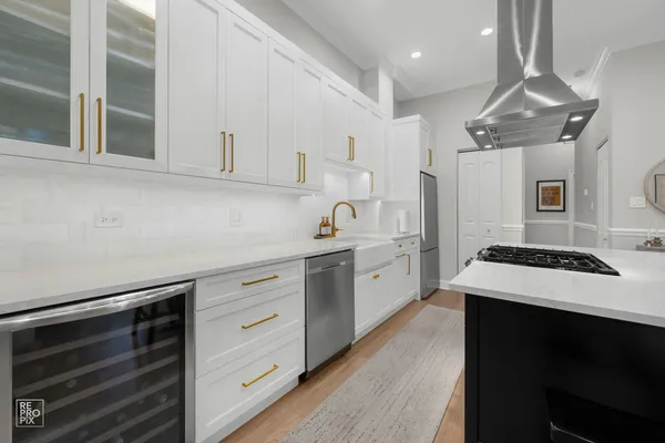 a kitchen with cabinets appliances a sink and a counter top space