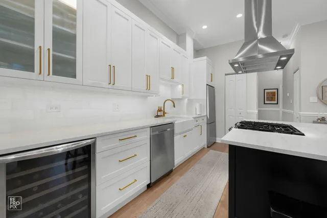 a kitchen with cabinets appliances a sink and a counter top space