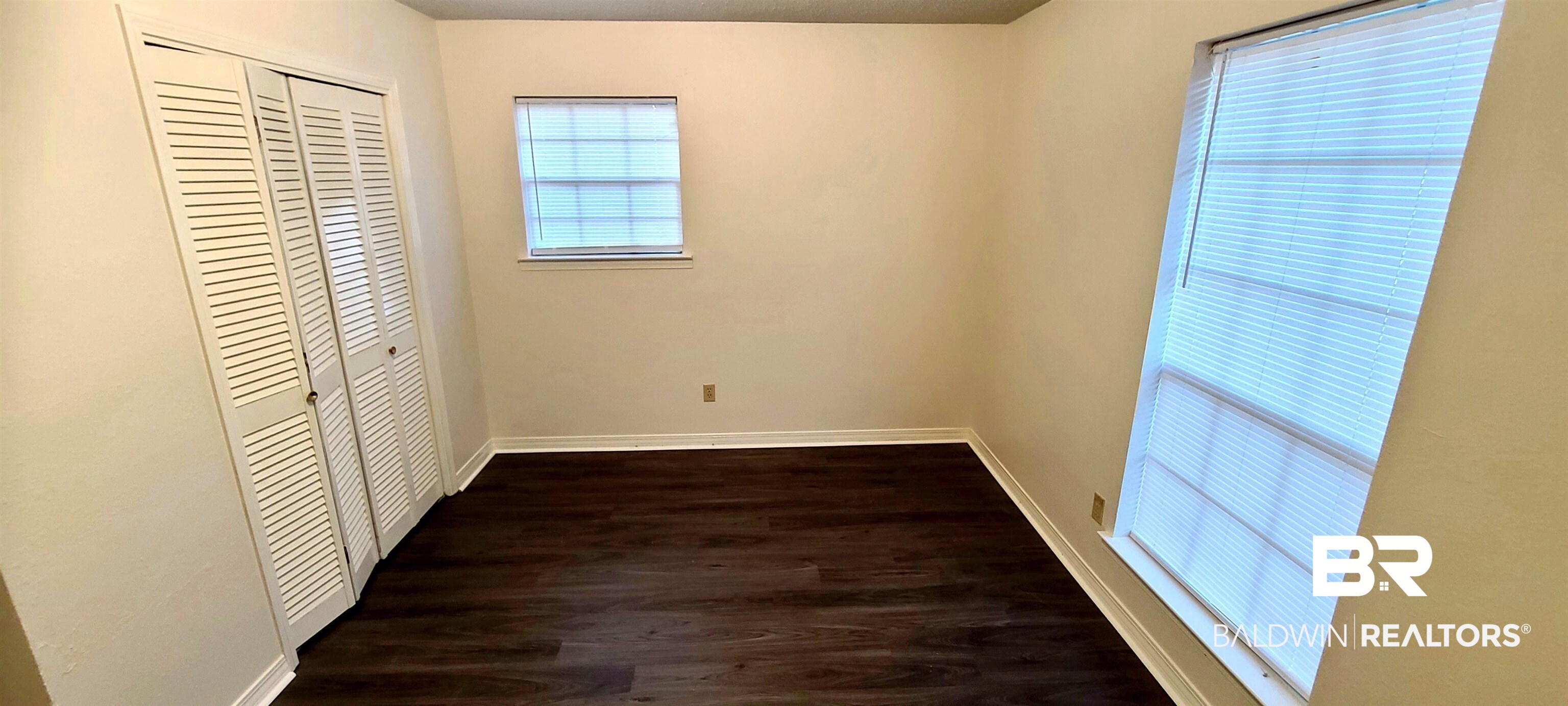 5305 Wilhelm Drive Mobile, AL 36618 - Photo 9 of 16 Unfurnished bedroom with a closet and dark hardwood / wood-style flooring