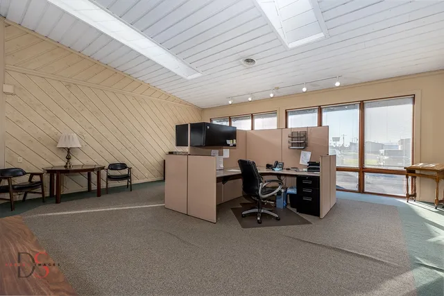 a view of a room with furniture and window