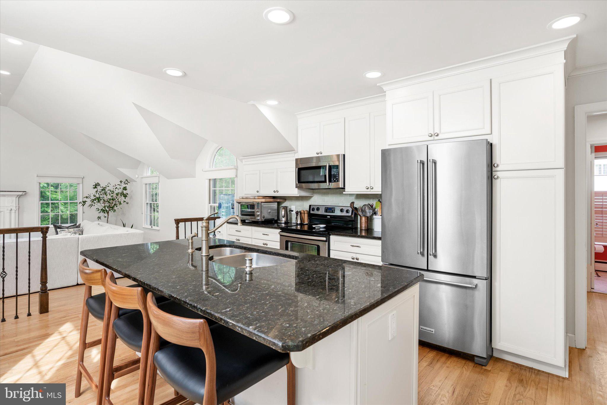 127 Westerly Road Princeton, NJ 08540 - Photo 13 of 30 a kitchen with stainless steel appliances granite countertop a refrigerator a stove a sink a dining table and chairs
