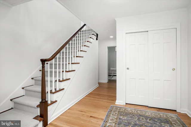 a view of entryway and hall with wooden floor