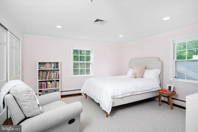 a bedroom with a bed furniture and a window