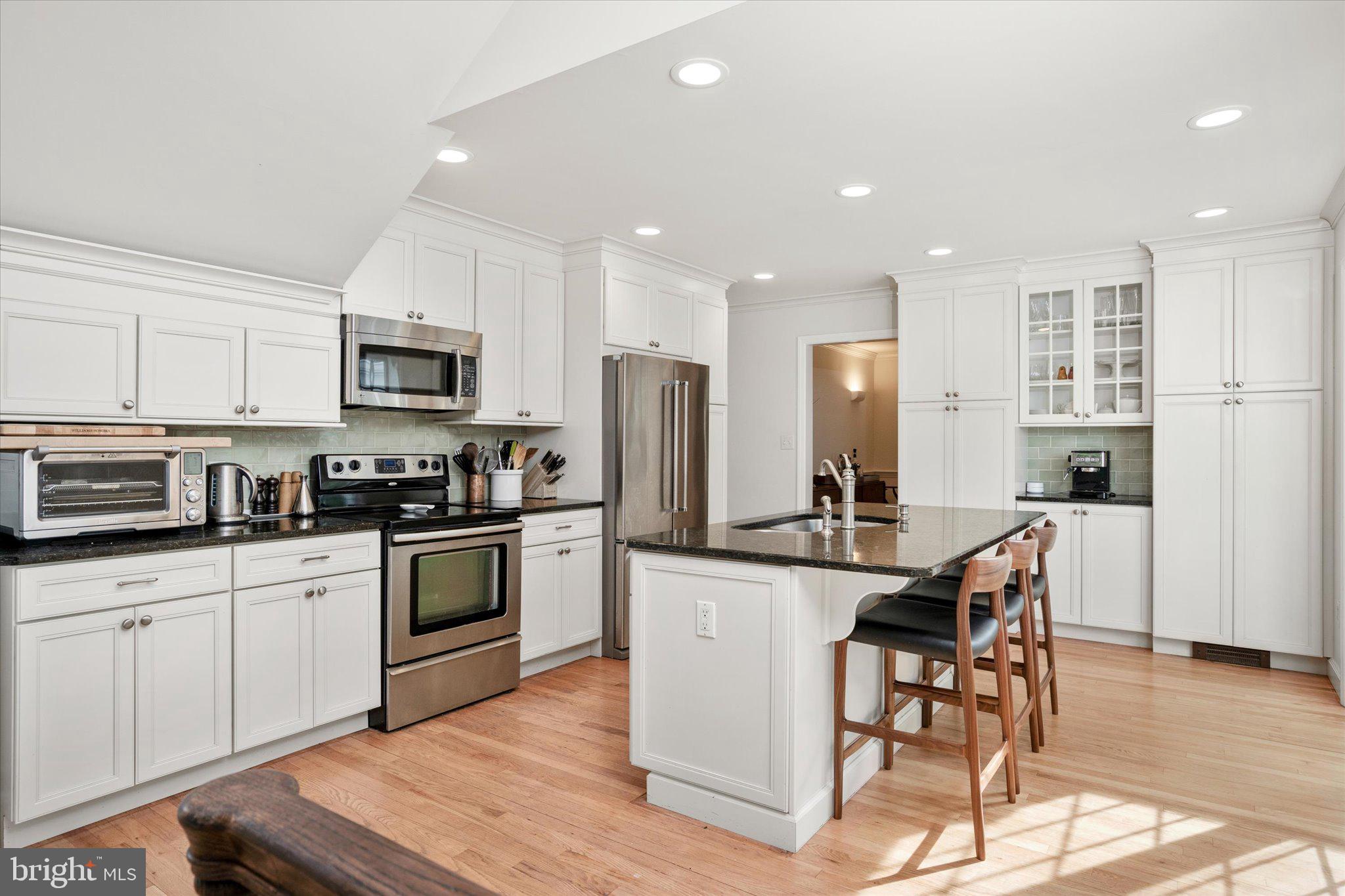 127 Westerly Road Princeton, NJ 08540 - Photo 3 of 30 a kitchen with stainless steel appliances granite countertop a stove top oven a sink dishwasher a refrigerator and white cabinets with wooden floor