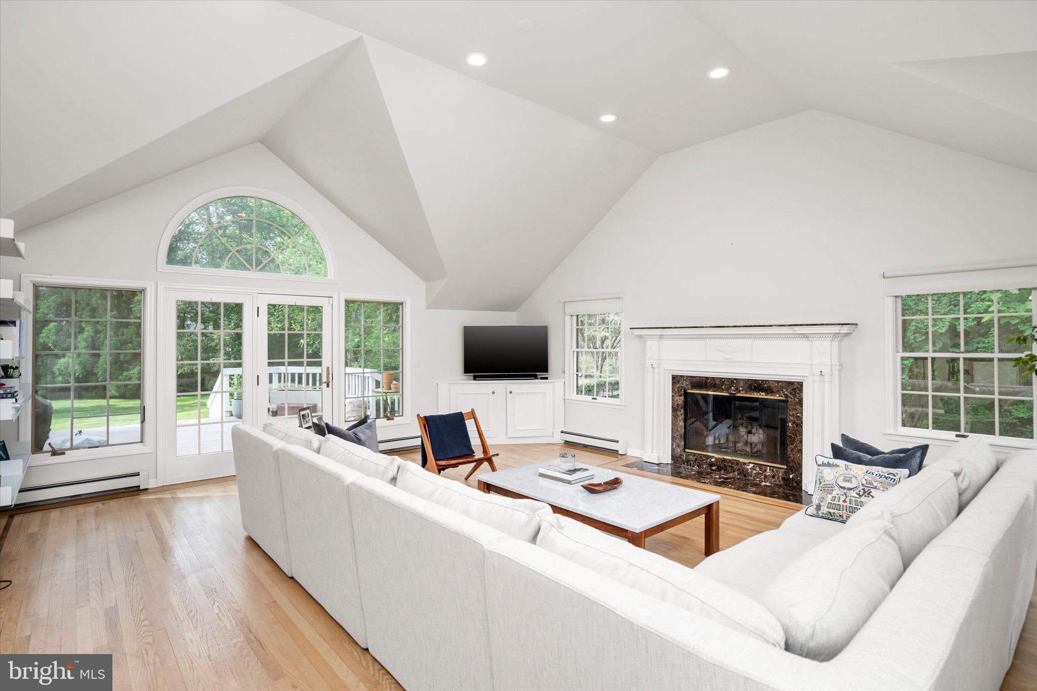 127 Westerly Road Princeton, NJ 08540 - Photo 10 of 30 a living room with furniture a flat screen tv and a fireplace