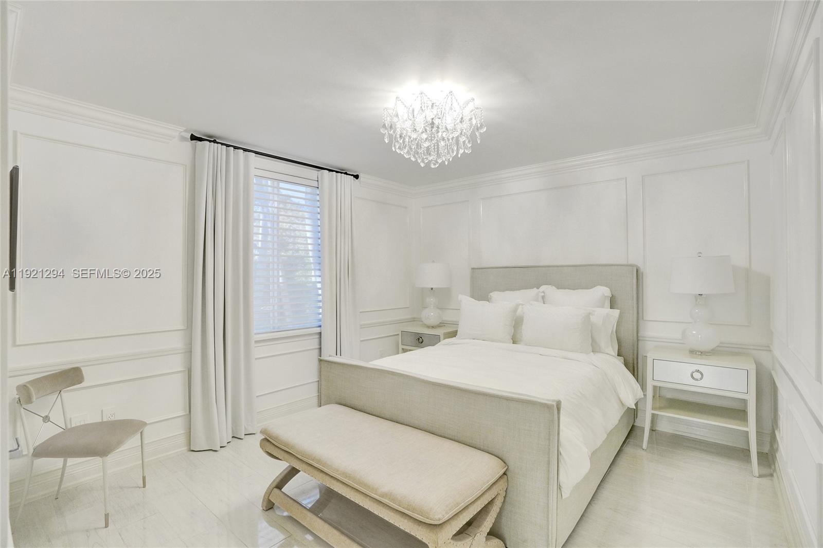 10400 Southwest 62nd Street Miami, FL 33173 - Photo 16 of 34 a bedroom with a bed and a chandelier