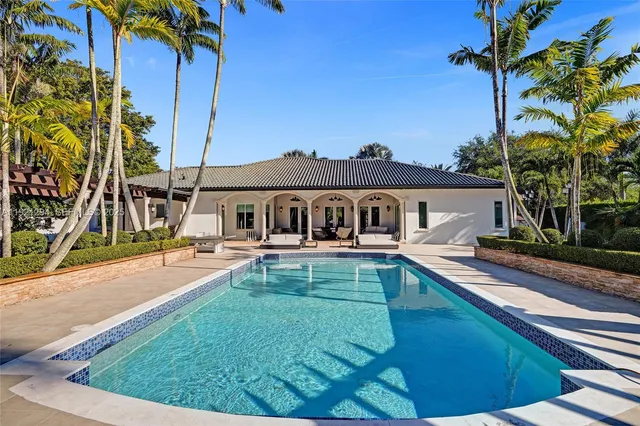 a front view of house with yard and swimming pool