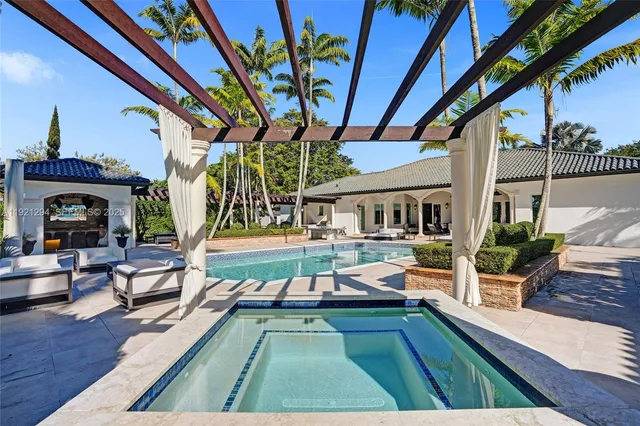 a view of house with swimming pool outdoor seating