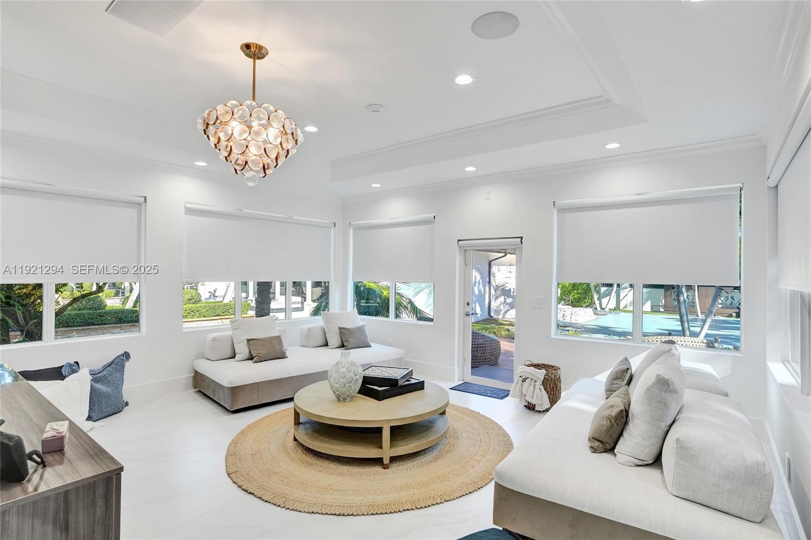 10400 Southwest 62nd Street Miami, FL 33173 - Photo 26 of 34 a living room with furniture chandelier and a fireplace