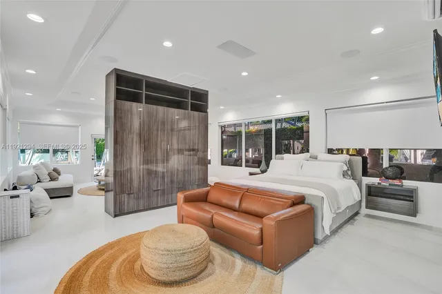 a large kitchen with kitchen island stainless steel appliances a stove a sink dishwasher and cabinets with wooden floor