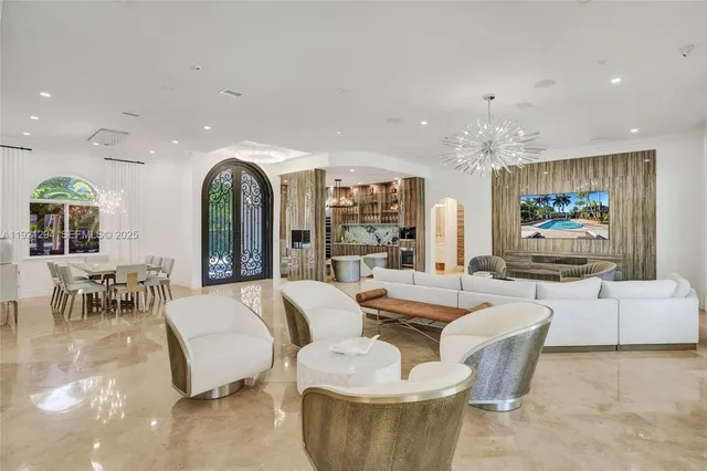 a living room with fireplace furniture and a chandelier