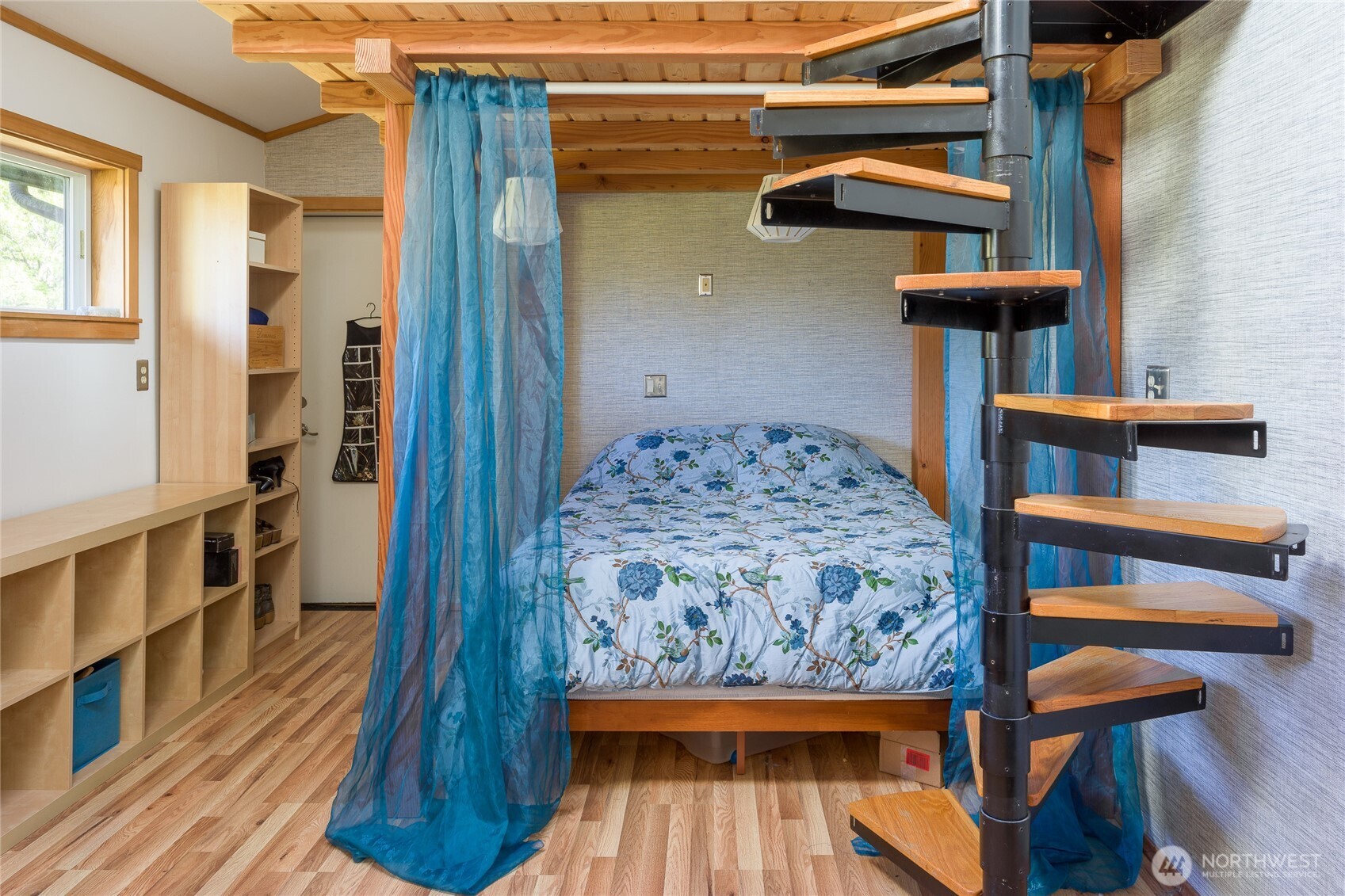 486 Wildwood Road Orcas Island, WA 98245 - Photo 20 of 37 a bedroom with a bed and a wooden floor