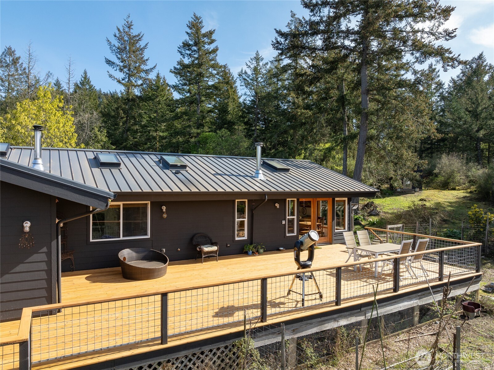 486 Wildwood Road Orcas Island, WA 98245 - Photo 26 of 37 a view of a house with pool and chairs