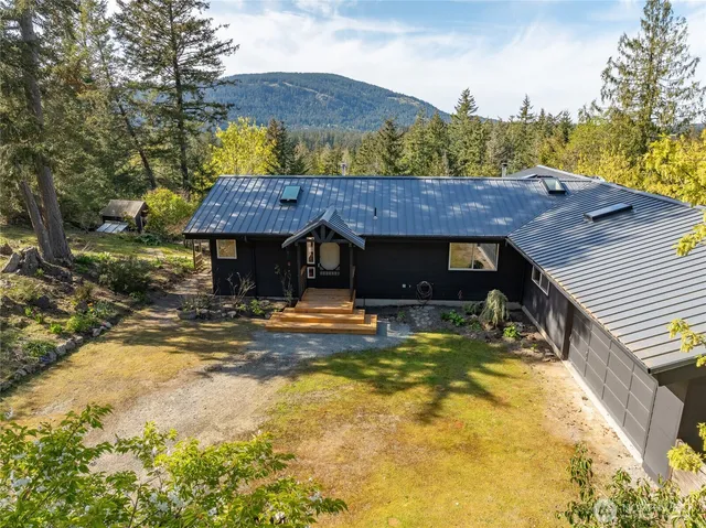 a view of a house with a swimming pool and a patio