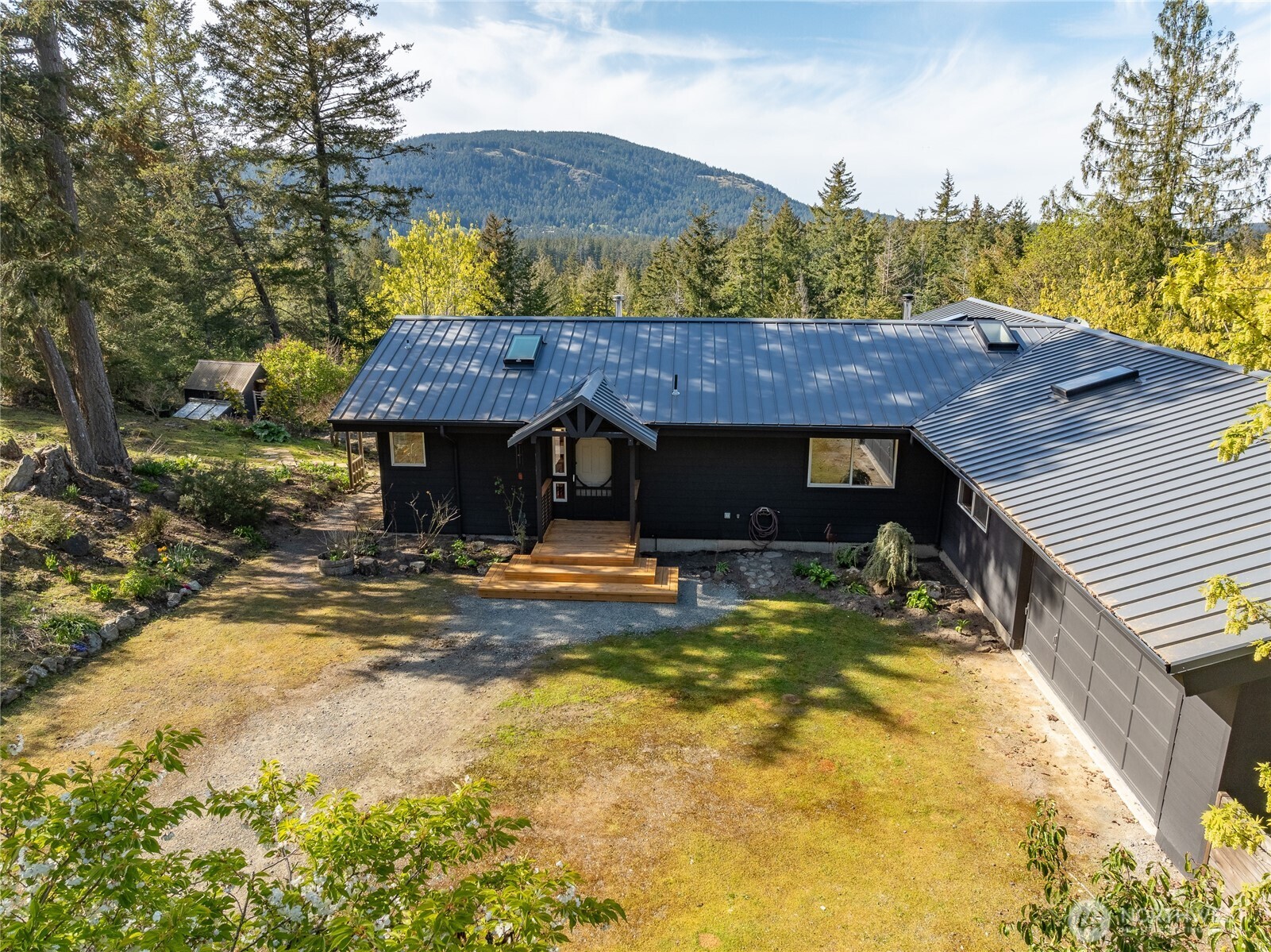 486 Wildwood Road Orcas Island, WA 98245 - Photo 30 of 37 a view of a house with a swimming pool and a patio