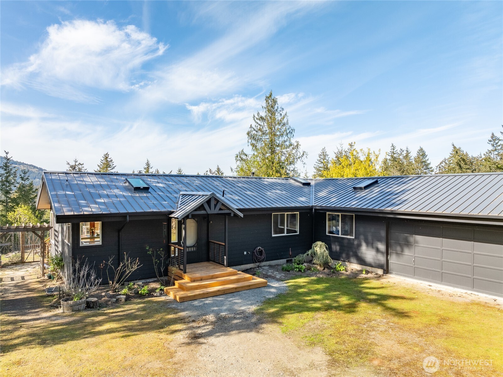 486 Wildwood Road Orcas Island, WA 98245 - Photo 4 of 37 a view of a dinning table and chairs in patio