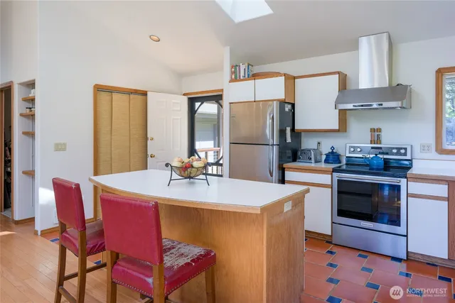 a kitchen with a sink a stove and chairs