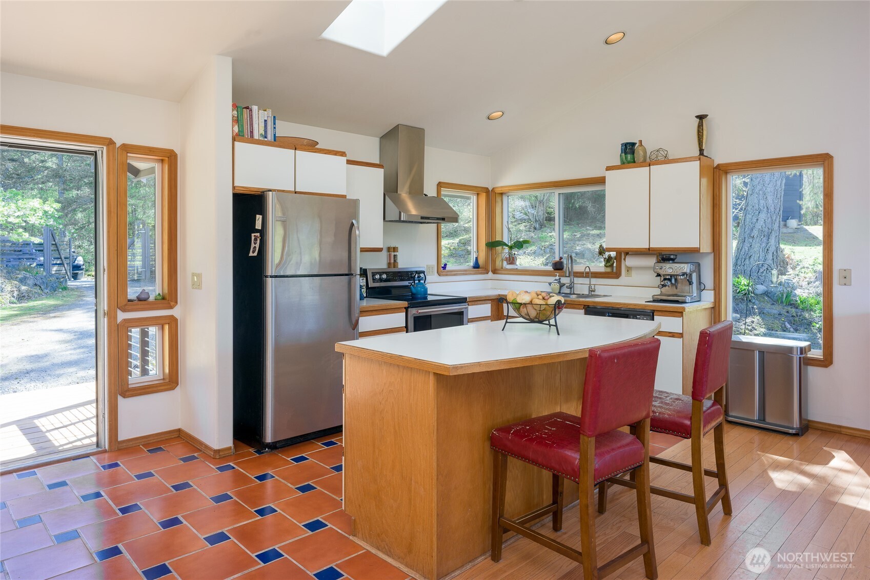 486 Wildwood Road Orcas Island, WA 98245 - Photo 8 of 37 a kitchen with a refrigerator a sink dishwasher and a stove with wooden floor