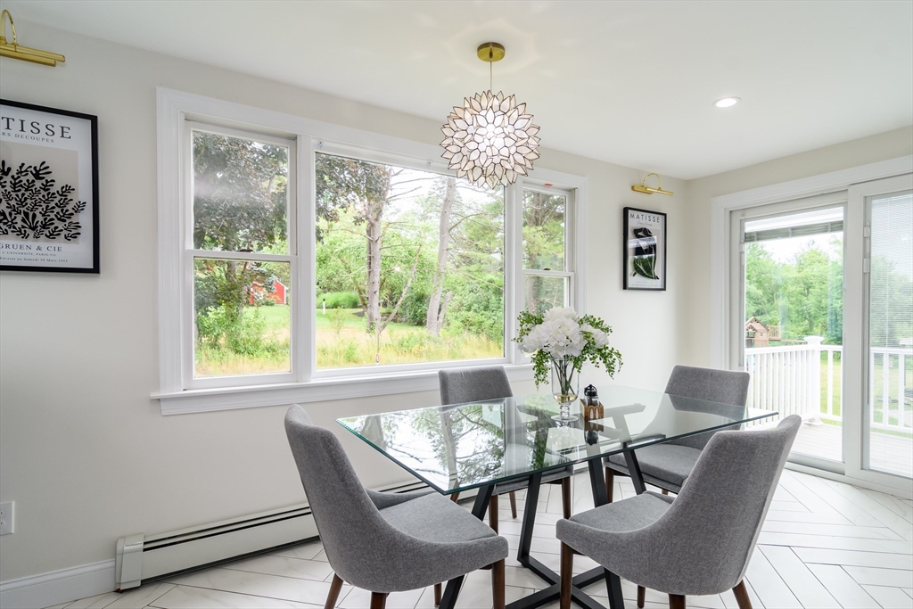 124 Everett Street Natick, MA 01760 - Photo 13 of 36 a view of a dining room with furniture a chandelier and wooden floor
