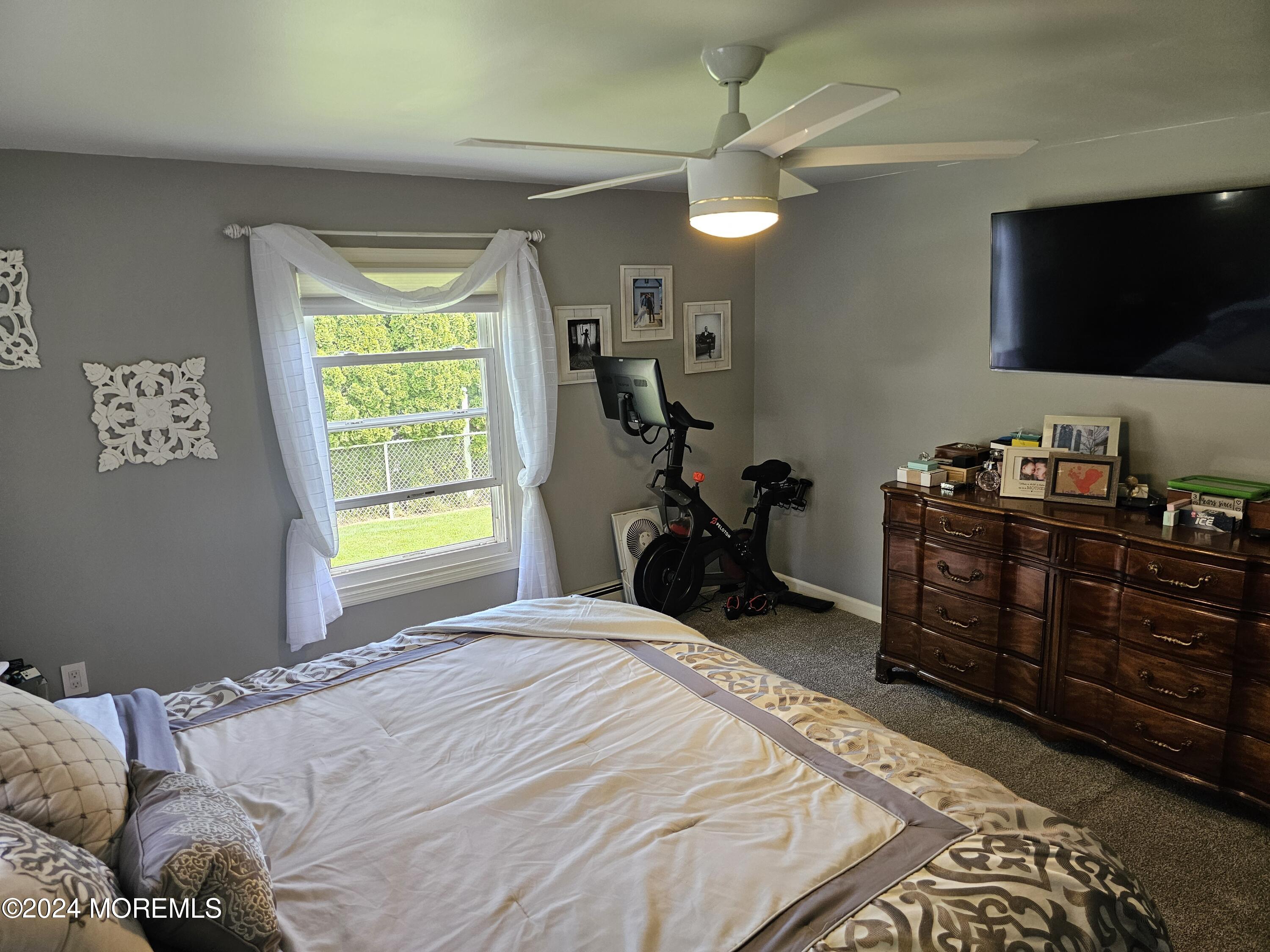 42 Middlesex Road Matawan, NJ 07747 - Photo 12 of 33 a bedroom with a bed window and a flat screen tv