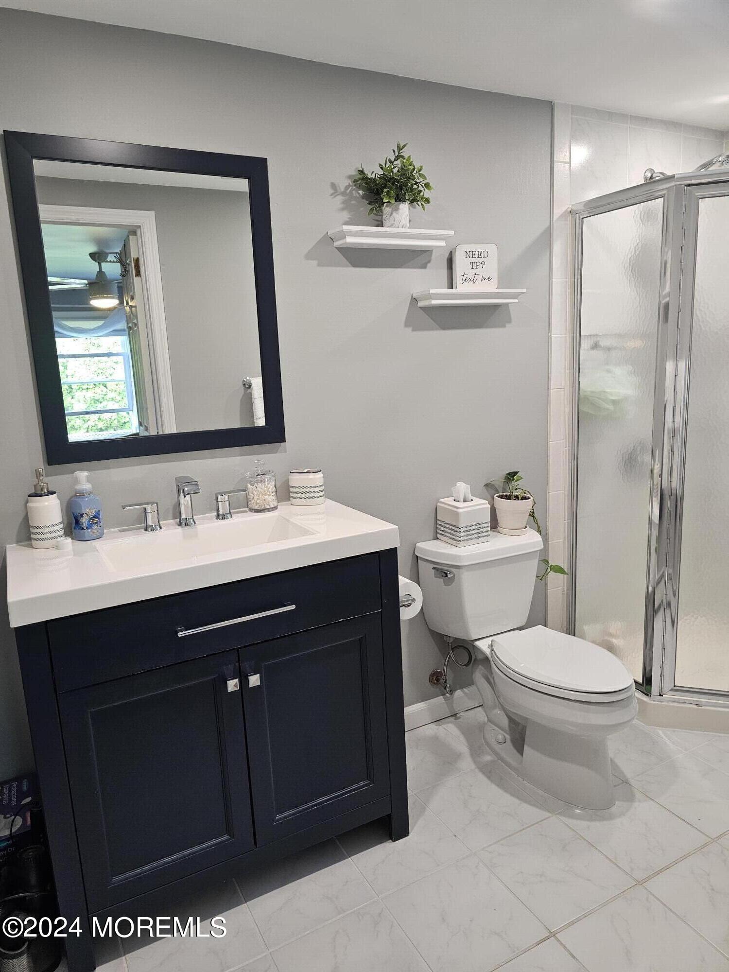 42 Middlesex Road Matawan, NJ 07747 - Photo 15 of 33 a bathroom with a sink vanity mirror and toilet