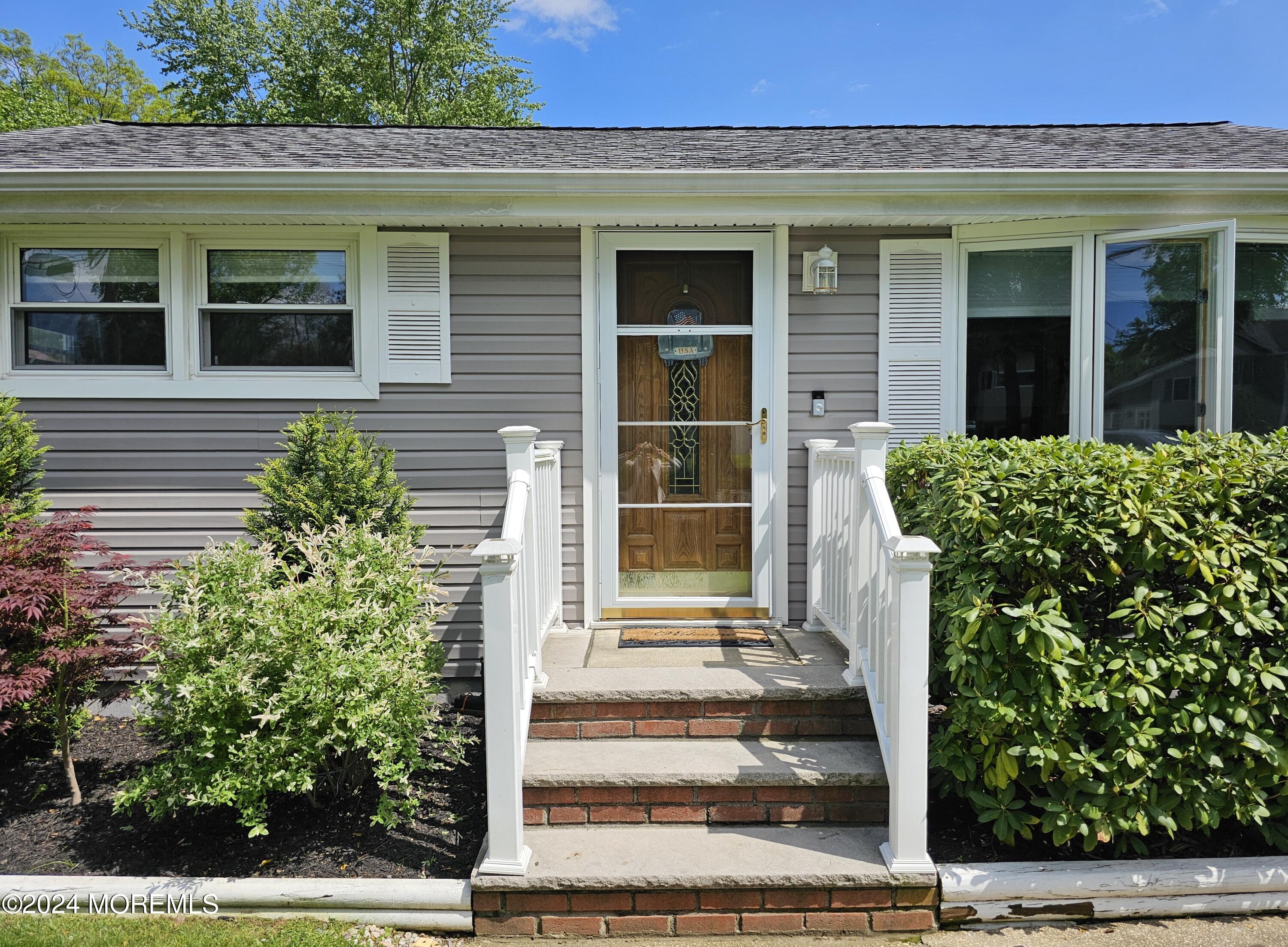 42 Middlesex Road Matawan, NJ 07747 - Photo 2 of 33 a front view of a house with a garden