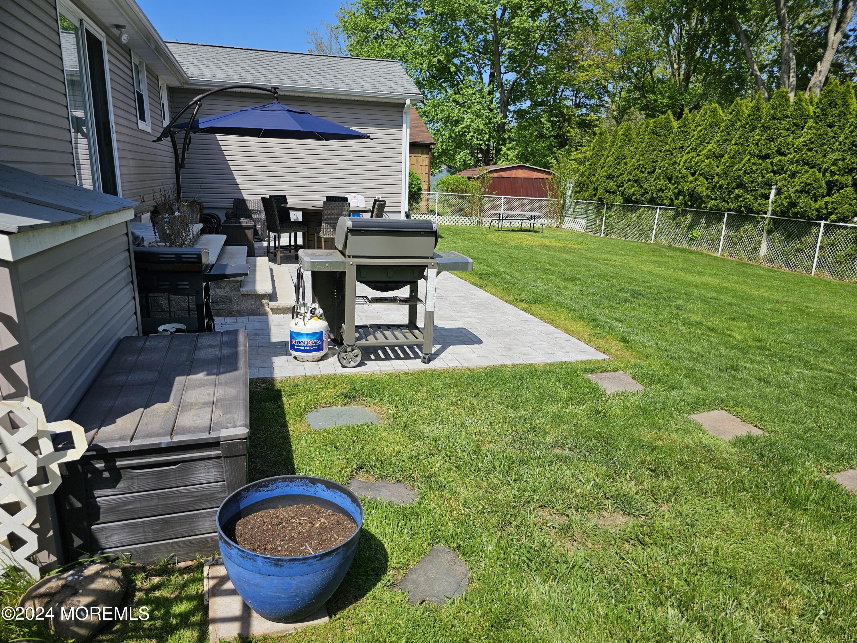42 Middlesex Road Matawan, NJ 07747 - Photo 24 of 33 a view of a chairs and table in backyard of the house