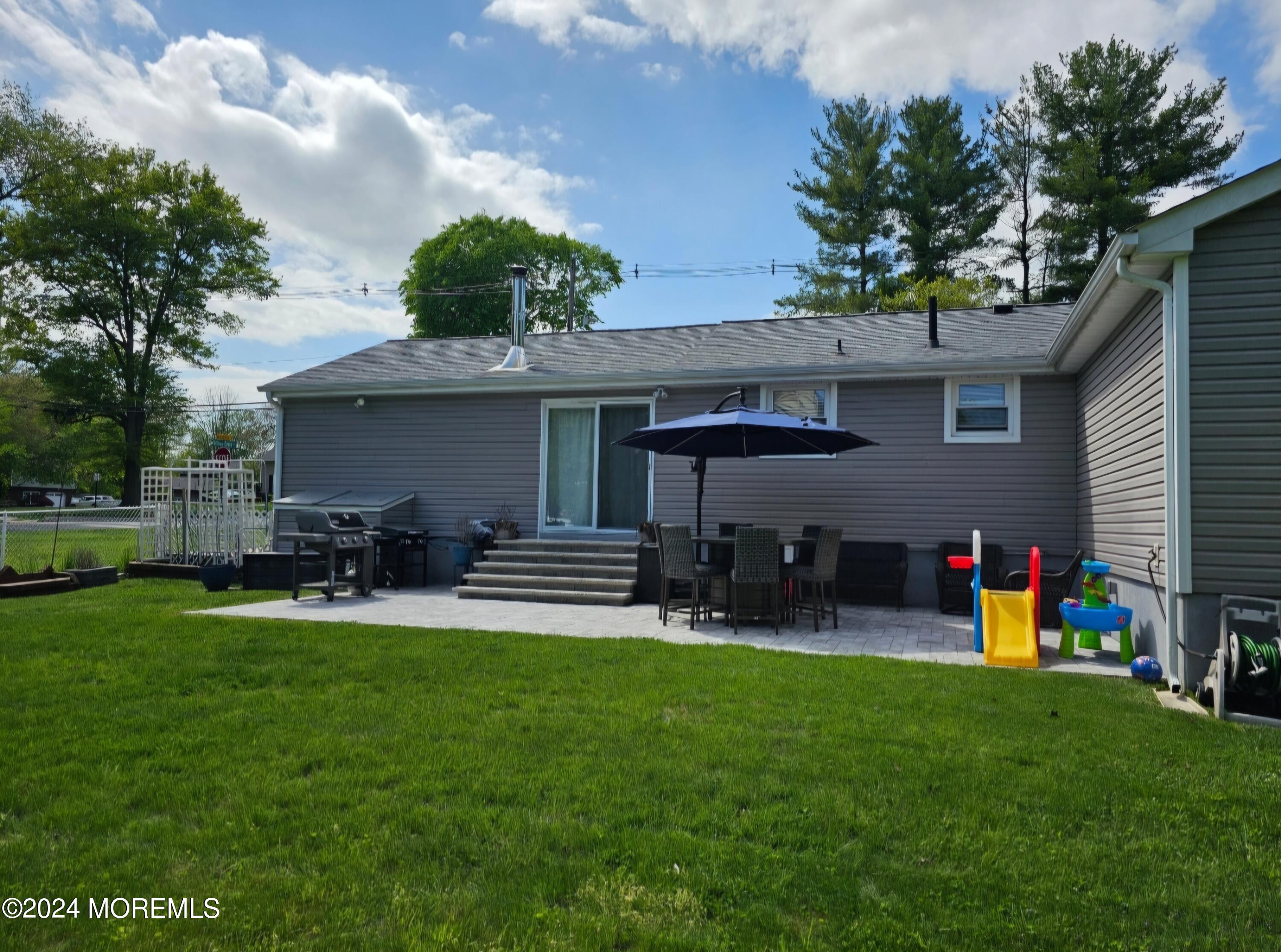 42 Middlesex Road Matawan, NJ 07747 - Photo 26 of 33 a front view of house with yard and outdoor seating