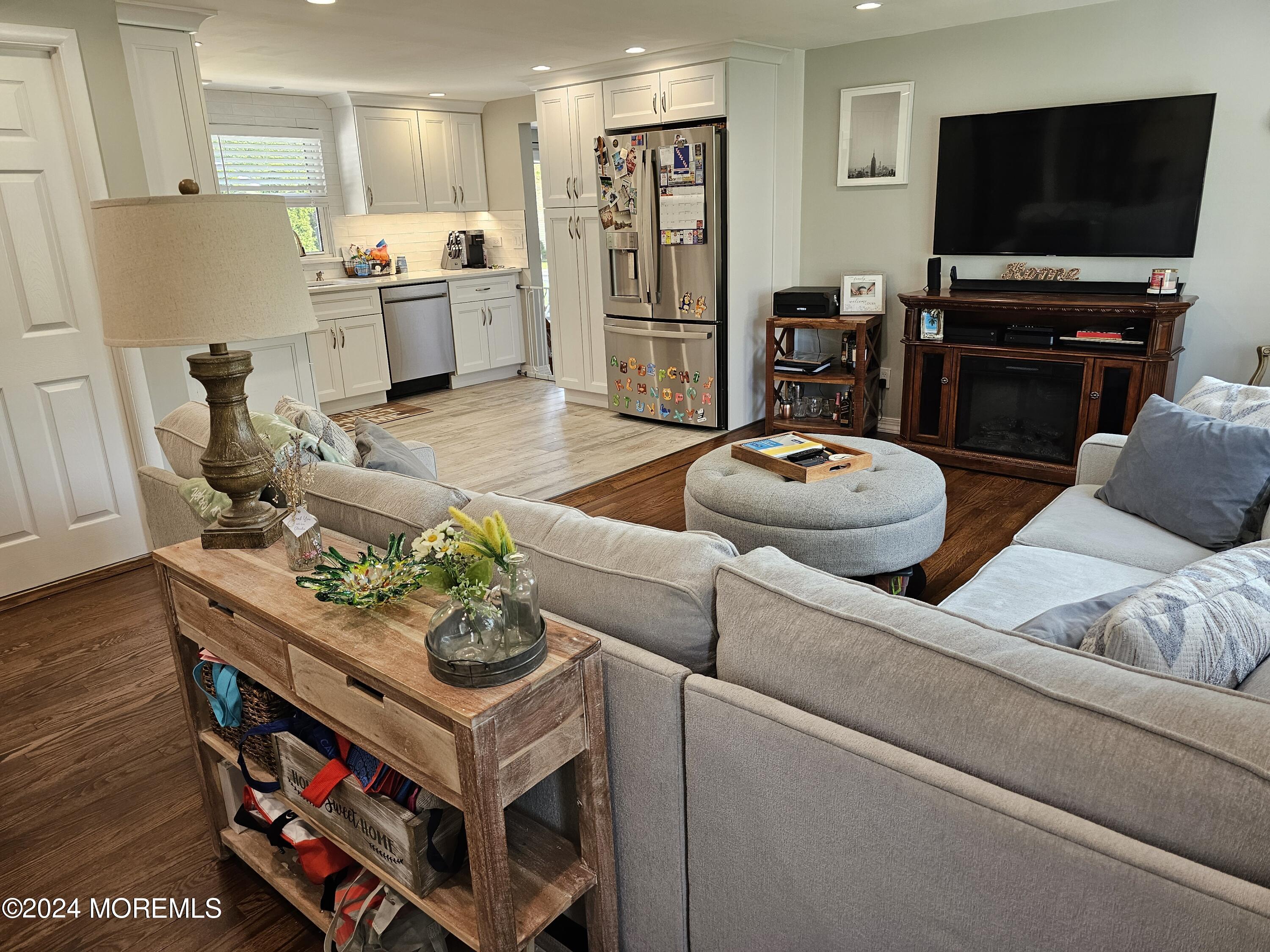 42 Middlesex Road Matawan, NJ 07747 - Photo 32 of 33 a living room with furniture and a flat screen tv
