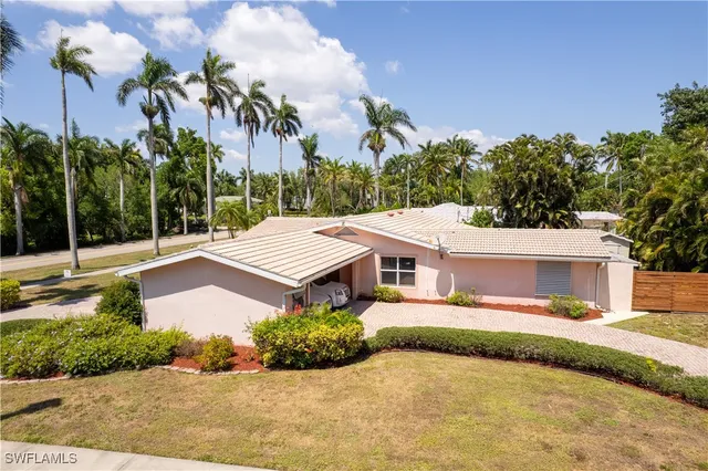 a view of a swimming pool with lounge chairs