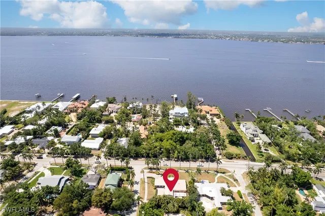 a living room with lots of furniture and view of kitchen