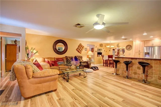 a kitchen with stainless steel appliances kitchen island granite countertop a table and chairs in it
