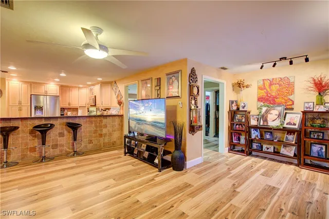 a living room with furniture a flat screen tv and gym equipment