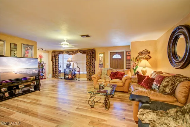 a kitchen with stainless steel appliances granite countertop a sink and cabinets with wooden floor