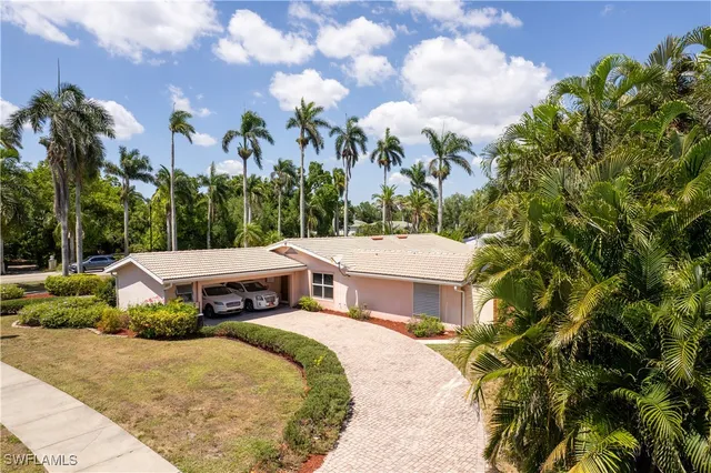 a view of a house with a yard and sitting area